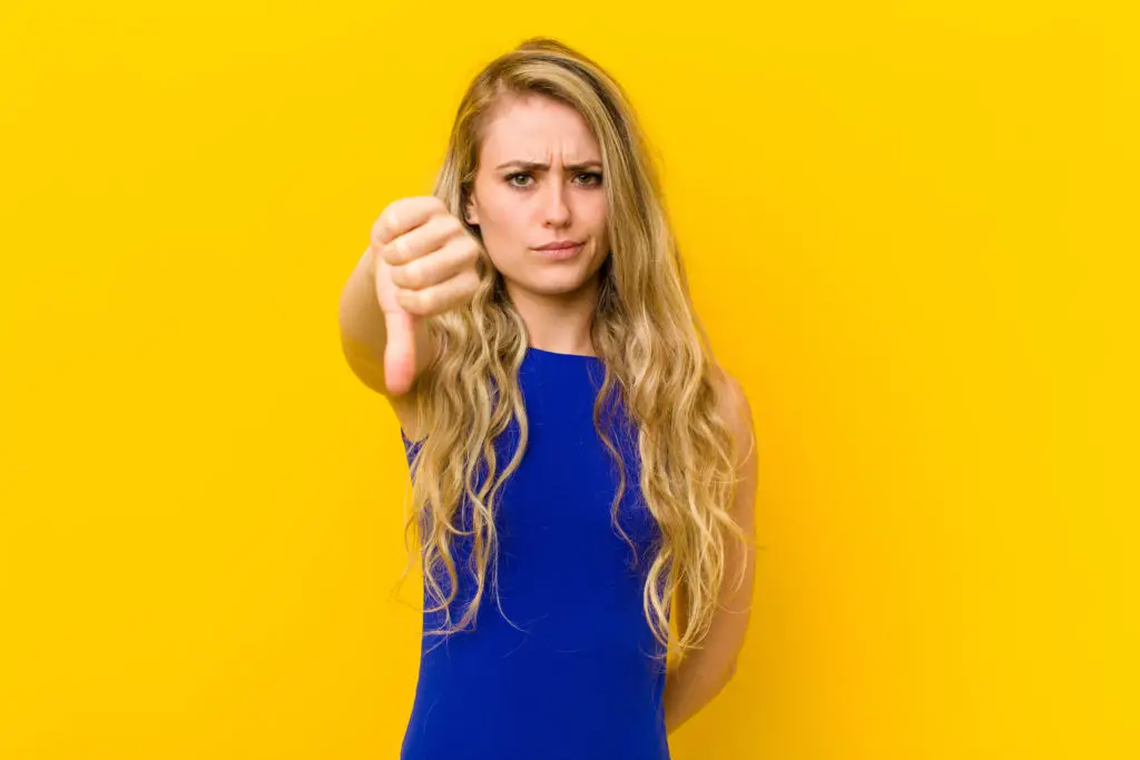 Woman gesturing thumbs down