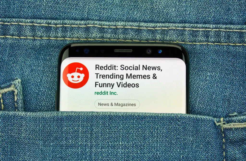 Smartphone in a pocket with an open Reddit app