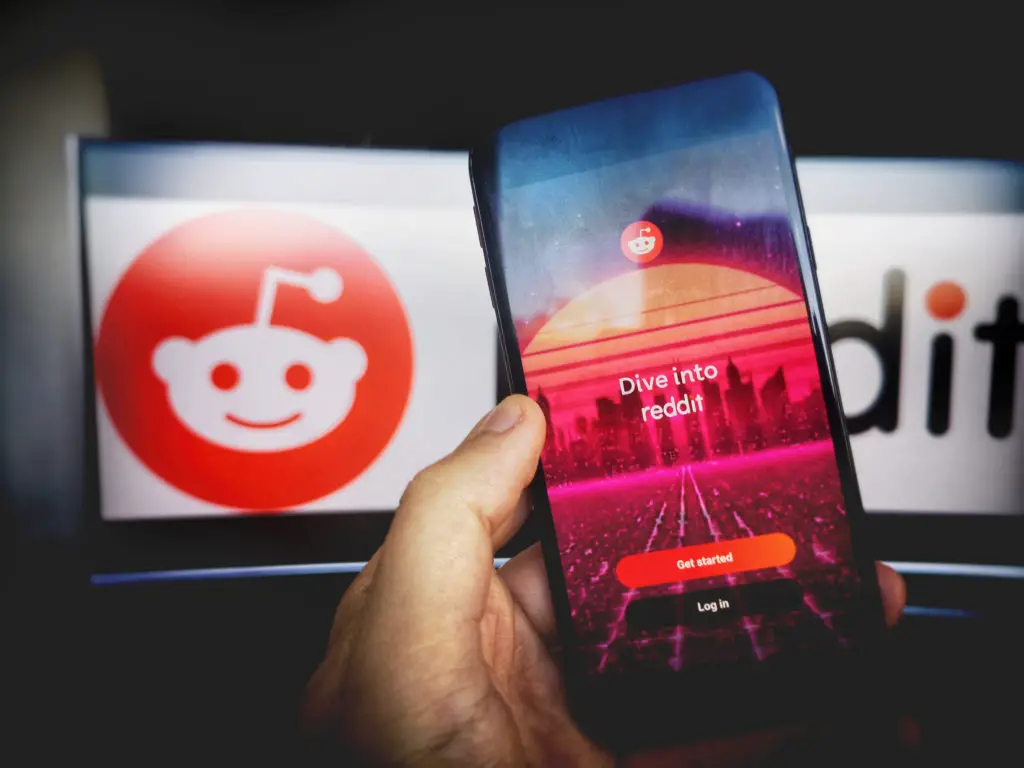 Reddit app opened on a smartphone and a computer