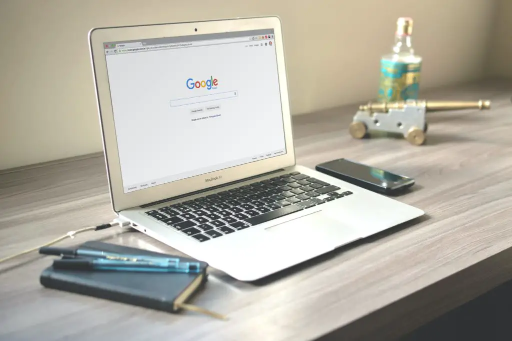 A laptop with Google homepage on the screen