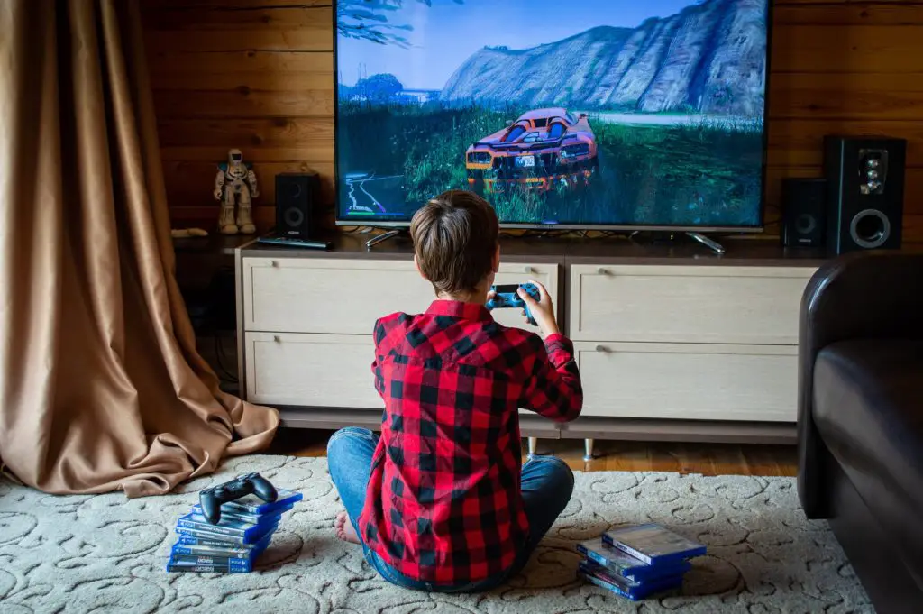 Boy playing a game on PlayStation4 console