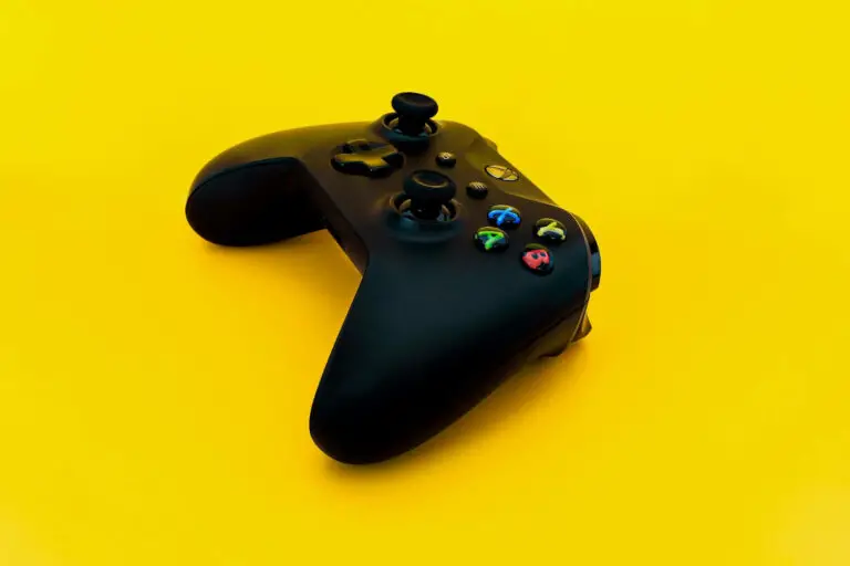 Black Xbox One game controller on yellow background