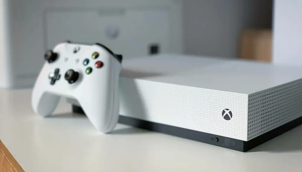 White Xbox One console next to the Xbox media remote