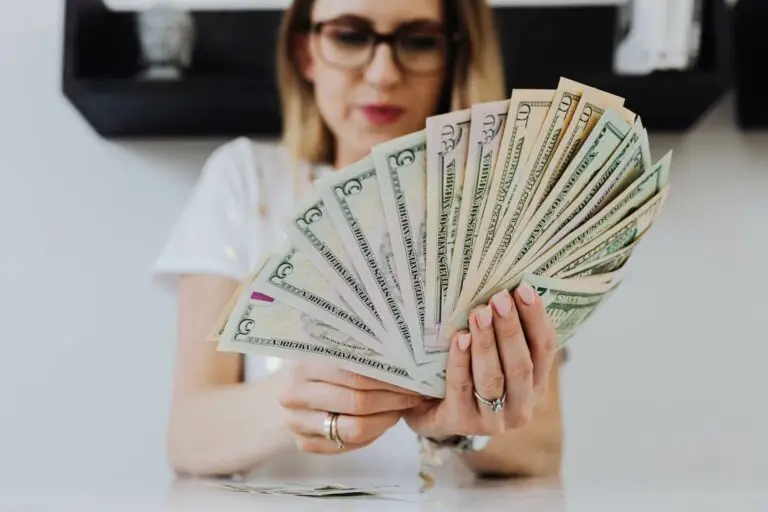 A woman holding dollar bills